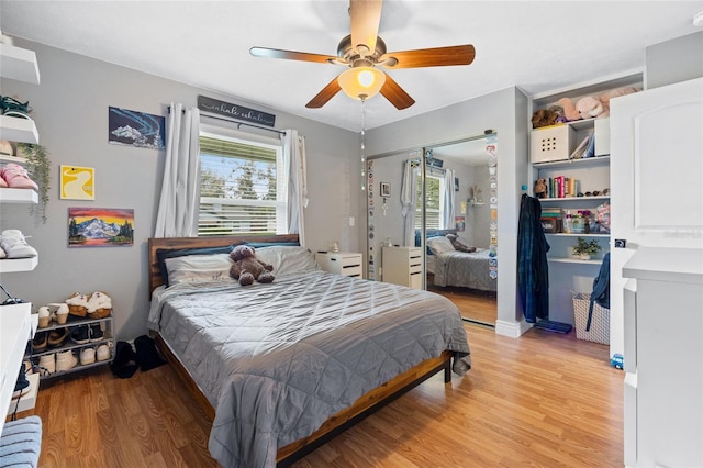 bedroom with a closet, ceiling fan, and light wood finished floors