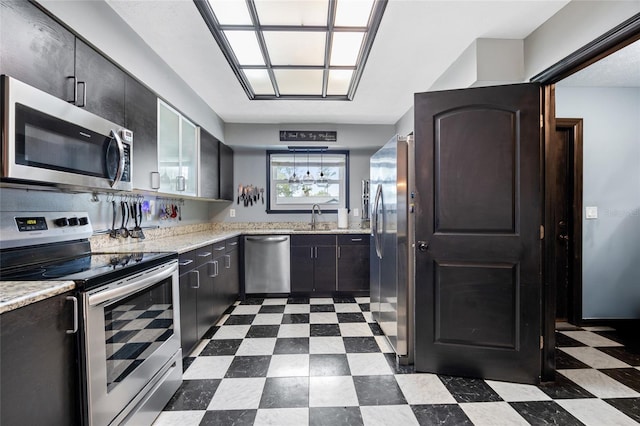 kitchen featuring a sink, stainless steel appliances, and dark floors