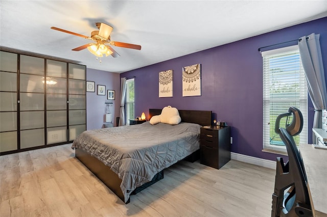 bedroom featuring baseboards, a ceiling fan, and wood finished floors