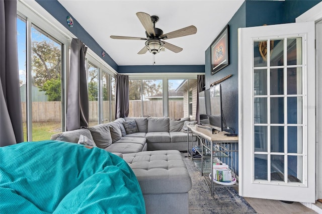 sunroom with a wealth of natural light and ceiling fan