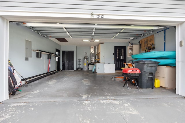 garage with electric panel, a garage door opener, and electric water heater