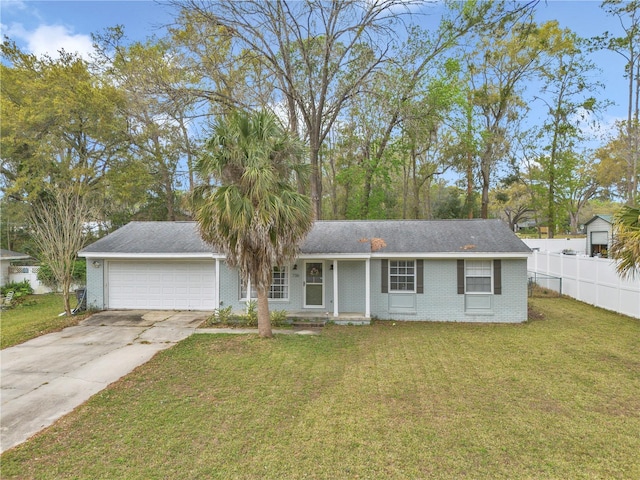 ranch-style home featuring a front yard, fence, driveway, an attached garage, and brick siding