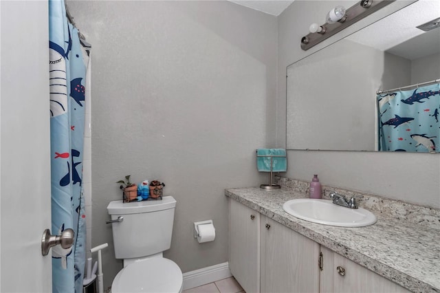 bathroom with vanity, a shower with curtain, baseboards, tile patterned floors, and toilet