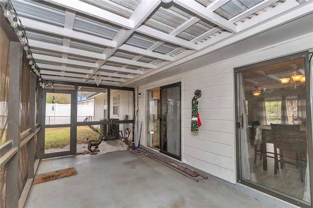 unfurnished sunroom featuring plenty of natural light and coffered ceiling