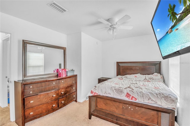 carpeted bedroom with visible vents and a ceiling fan