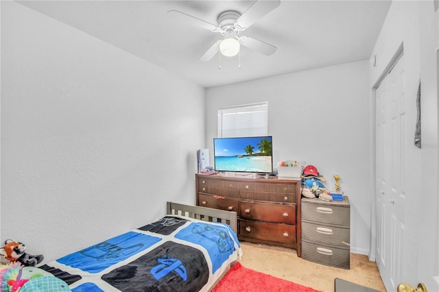 carpeted bedroom featuring a closet and a ceiling fan