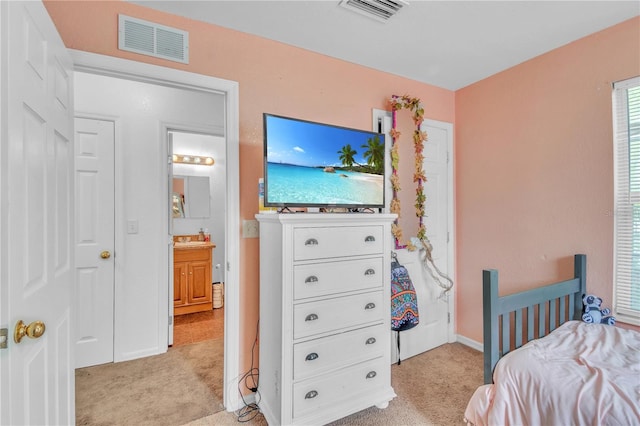 bedroom with baseboards, visible vents, and light carpet