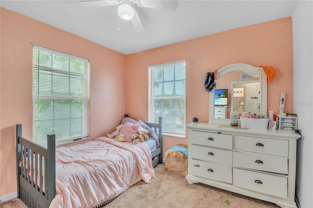 bedroom with ceiling fan and light carpet