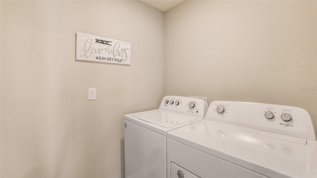 washroom featuring laundry area and washing machine and dryer