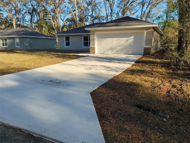 ranch-style home with concrete driveway, an attached garage, brick siding, and a front lawn