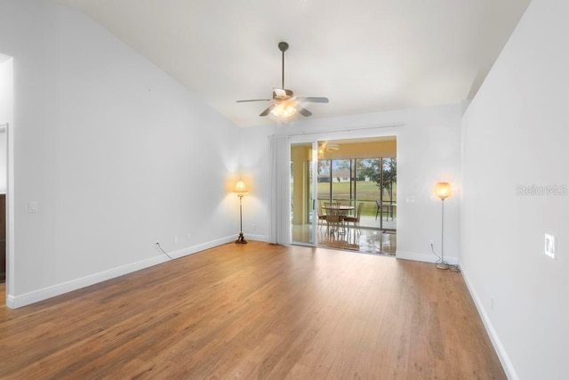 spare room with ceiling fan, baseboards, and wood finished floors