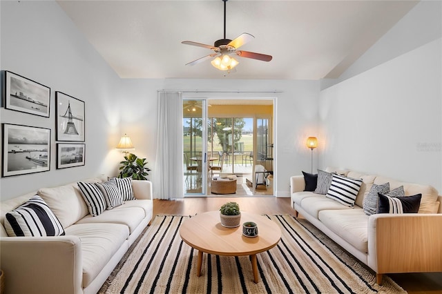 living room featuring wood finished floors, ceiling fan, and vaulted ceiling