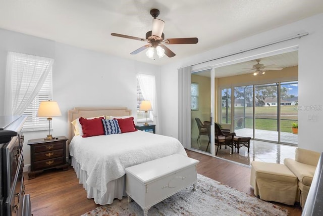 bedroom featuring a ceiling fan, access to exterior, and wood finished floors