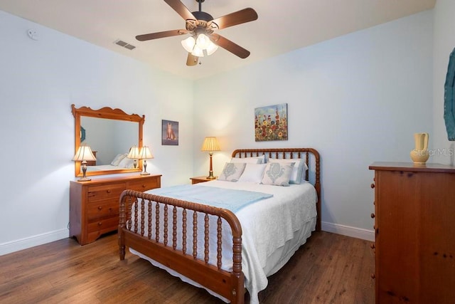 bedroom featuring visible vents, baseboards, and wood finished floors