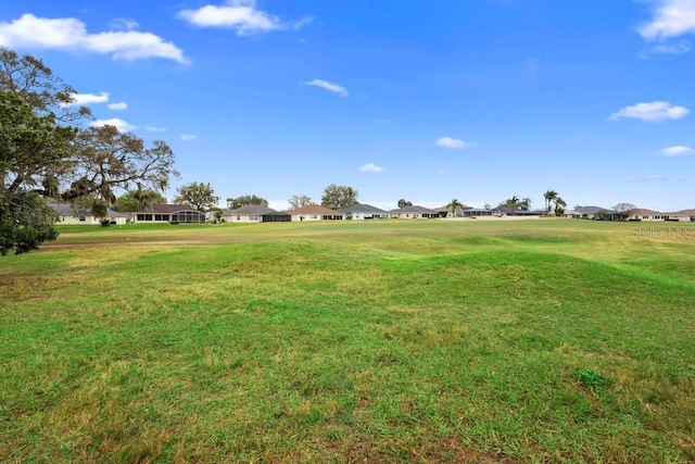 surrounding community with a residential view and a yard