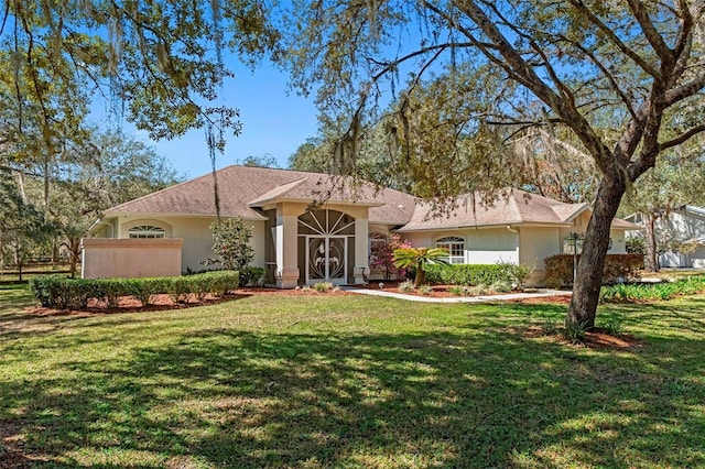 single story home featuring stucco siding and a front lawn