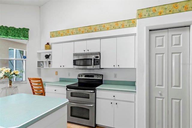 kitchen featuring white cabinetry, light countertops, and appliances with stainless steel finishes