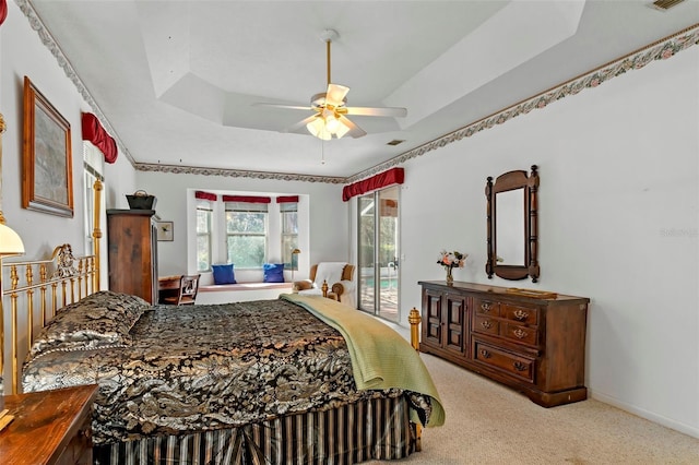 carpeted bedroom featuring a ceiling fan, baseboards, visible vents, access to exterior, and a raised ceiling