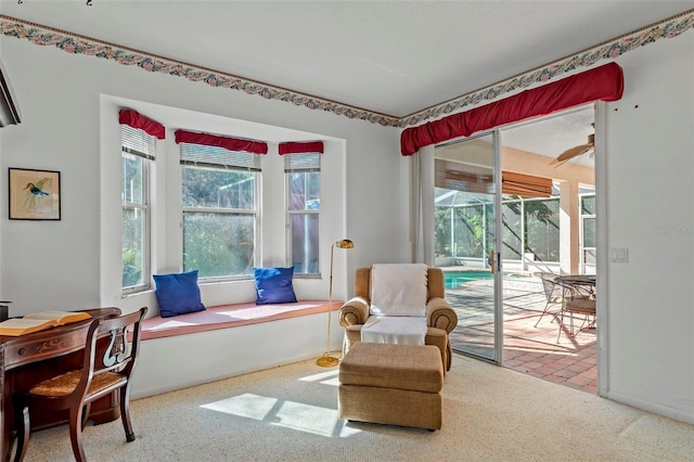 living area with baseboards and a sunroom