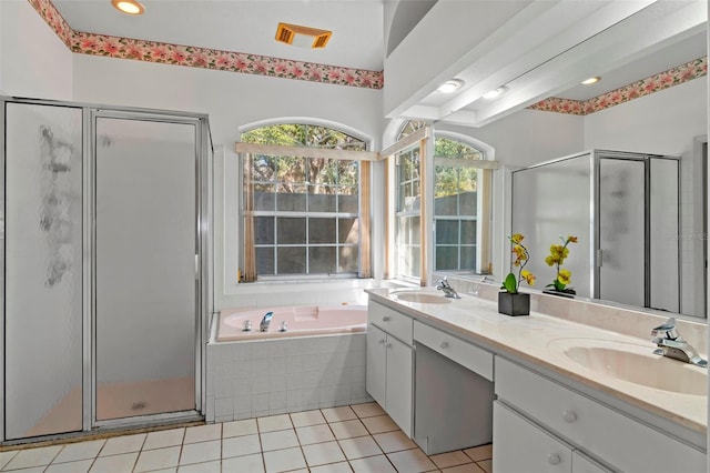 bathroom with a bath, a shower stall, and a sink