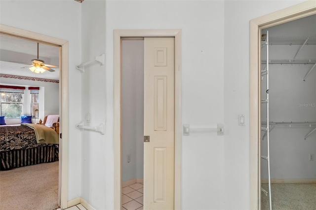 ensuite bathroom with a closet, baseboards, ensuite bathroom, and ceiling fan