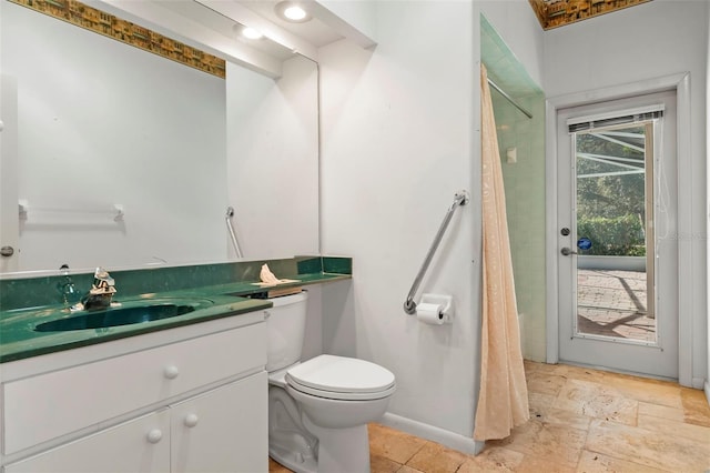 full bath with vanity, stone tile floors, toilet, and a shower with curtain