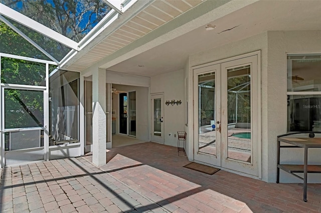 view of patio with a lanai and french doors