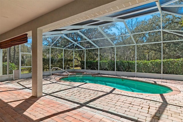 outdoor pool with a lanai and a patio area