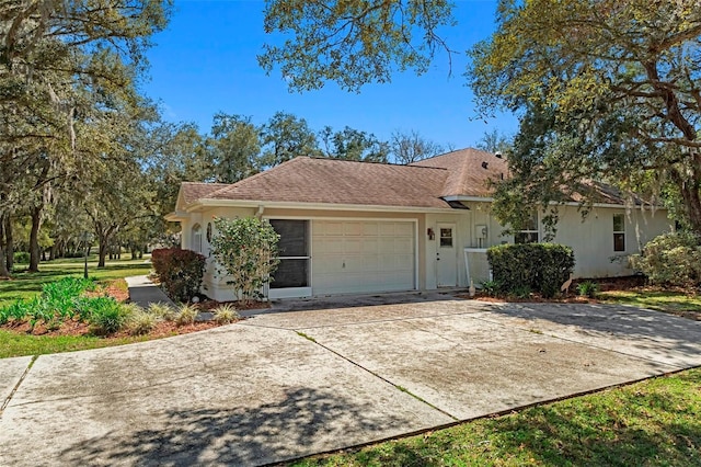 view of front of home featuring an attached garage and concrete driveway