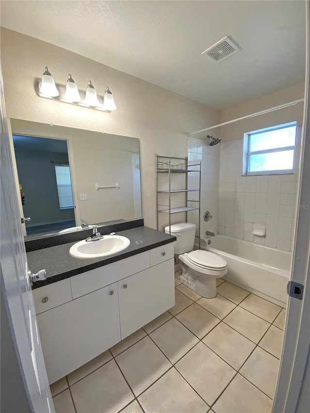 bathroom with tile patterned flooring, visible vents, toilet, bathing tub / shower combination, and vanity