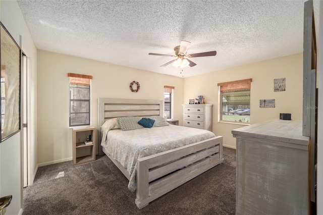 bedroom featuring a ceiling fan, baseboards, dark carpet, and a textured ceiling