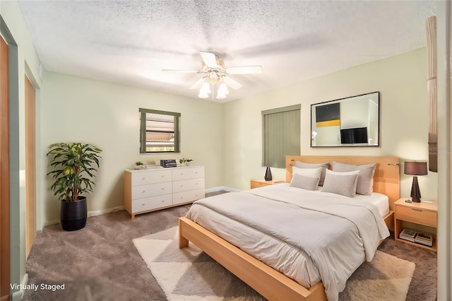 carpeted bedroom with baseboards, a textured ceiling, and a ceiling fan