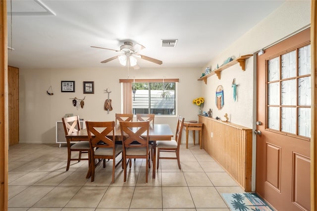 dining space with light tile patterned flooring, a ceiling fan, and visible vents