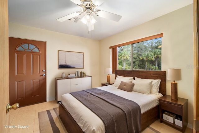 bedroom with light tile patterned flooring, visible vents, and ceiling fan