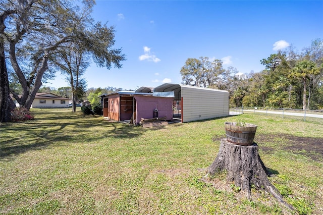 view of yard with an outdoor structure and fence