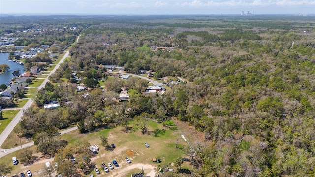 aerial view featuring a forest view and a water view