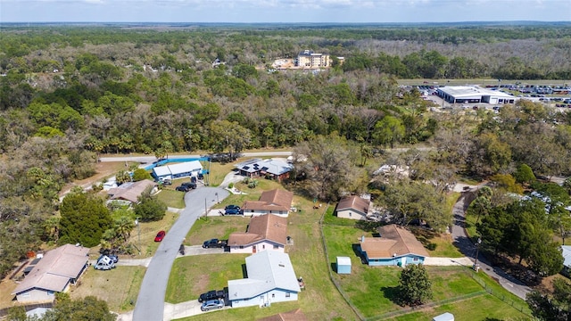 aerial view with a wooded view and a residential view