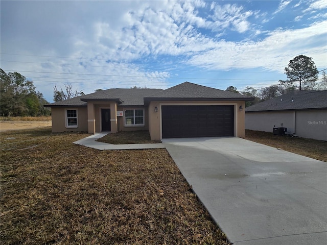 view of front of property with concrete driveway, central air condition unit, an attached garage, and stucco siding