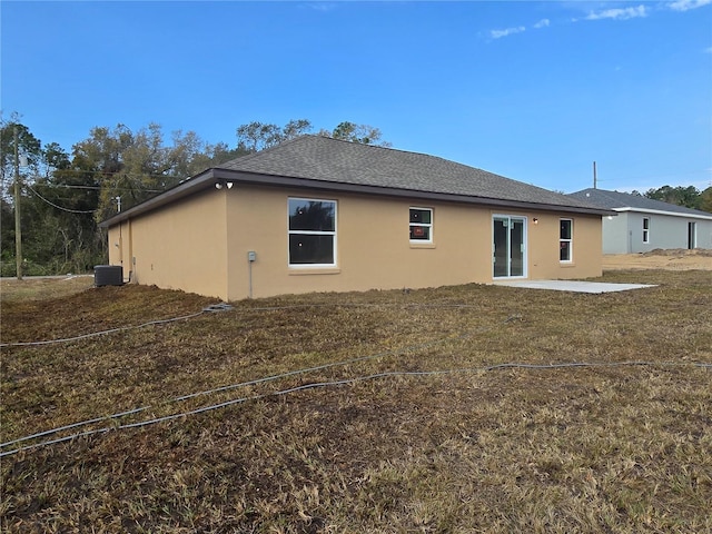 rear view of property with cooling unit, stucco siding, and a patio area