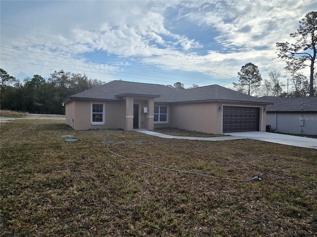 view of front of home with stucco siding, driveway, a front yard, and an attached garage