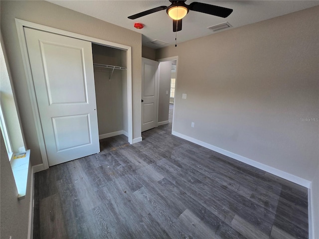 unfurnished bedroom with visible vents, ceiling fan, baseboards, a closet, and dark wood-style floors