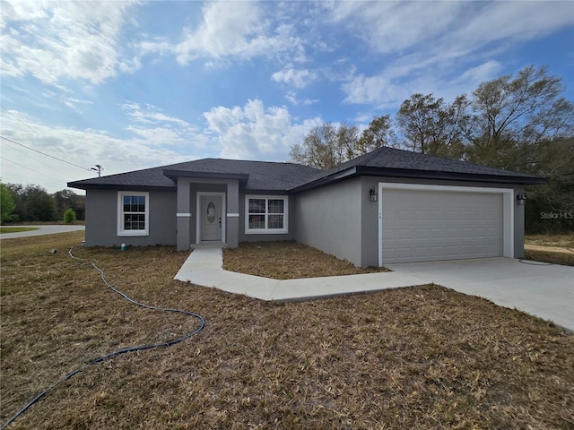 view of front of property with roof with shingles, an attached garage, driveway, and stucco siding