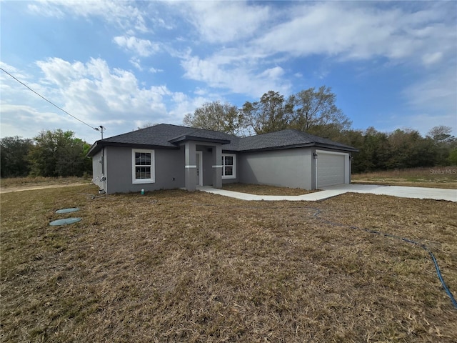 view of front of property featuring stucco siding, a front lawn, concrete driveway, and an attached garage