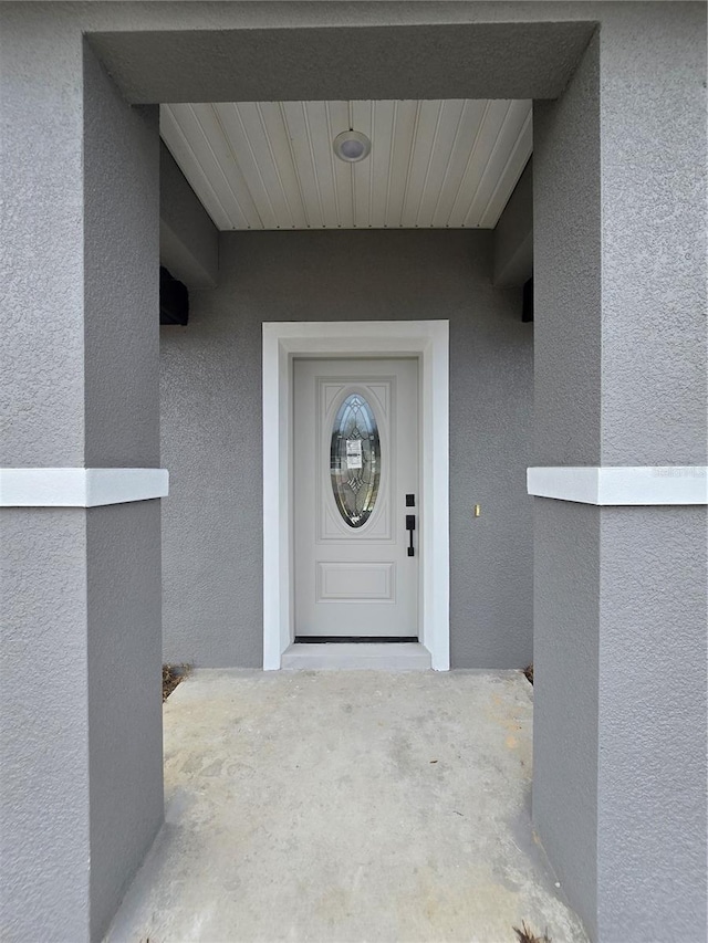 property entrance featuring stucco siding