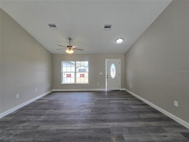 foyer featuring a ceiling fan, dark wood-type flooring, baseboards, and visible vents