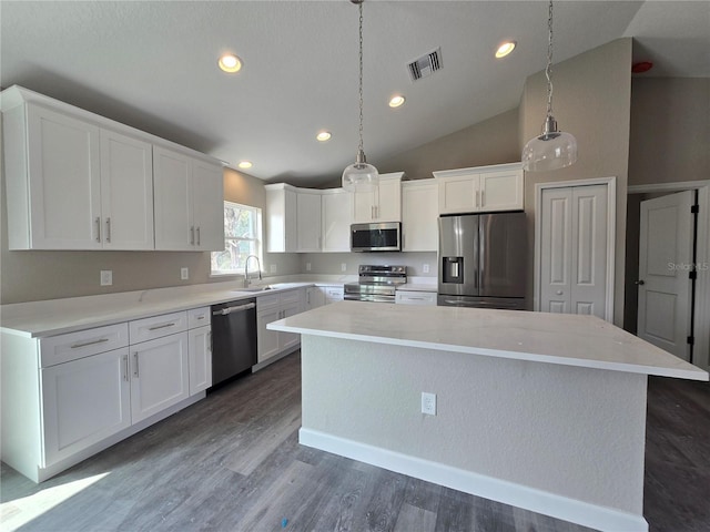 kitchen featuring visible vents, white cabinetry, appliances with stainless steel finishes, and a center island