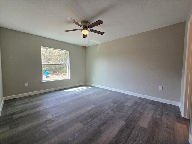 unfurnished room featuring baseboards, a ceiling fan, and dark wood-style flooring