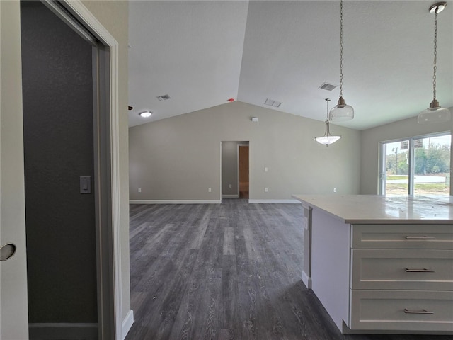 kitchen featuring visible vents, lofted ceiling, dark wood-type flooring, and light countertops