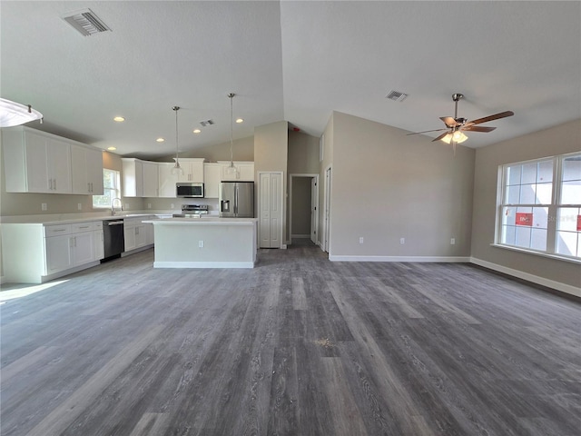 kitchen featuring a center island, open floor plan, stainless steel appliances, and visible vents