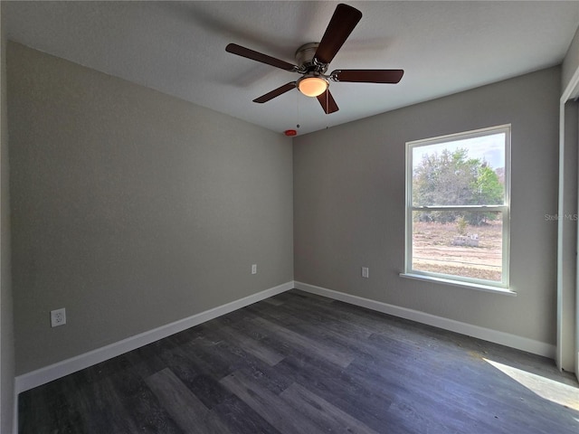 unfurnished room with ceiling fan, baseboards, and dark wood finished floors